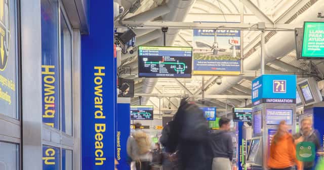 An AirTrain station at JFK, shown as a representative airport photograph. Display boards in the image are not the live October 2026 operating schedule.