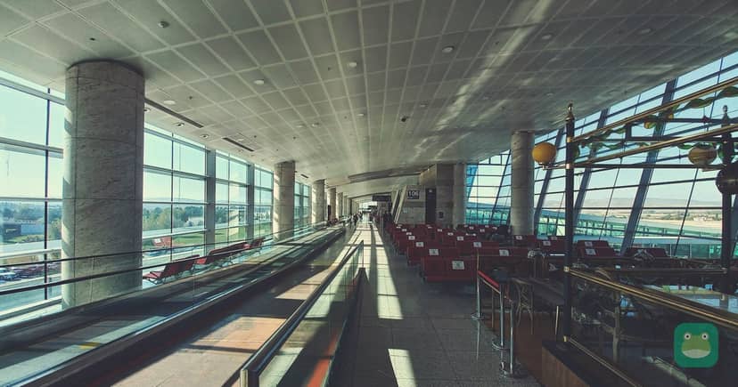 A long, level departure concourse lined with windows