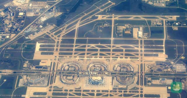 An aerial view of Dallas Fort Worth International Airport and its semicircular terminals