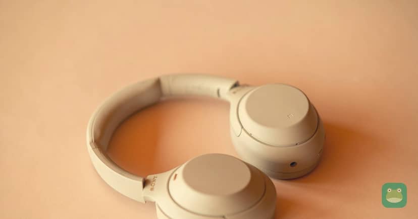 A pair of Sony wireless headphones on a desk